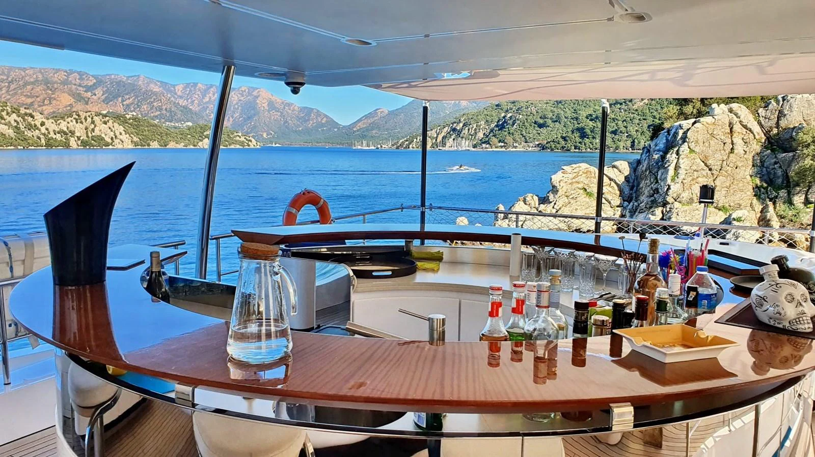 a table with bottles and glasses on it aboard R.DARENBEN Yacht for Sale