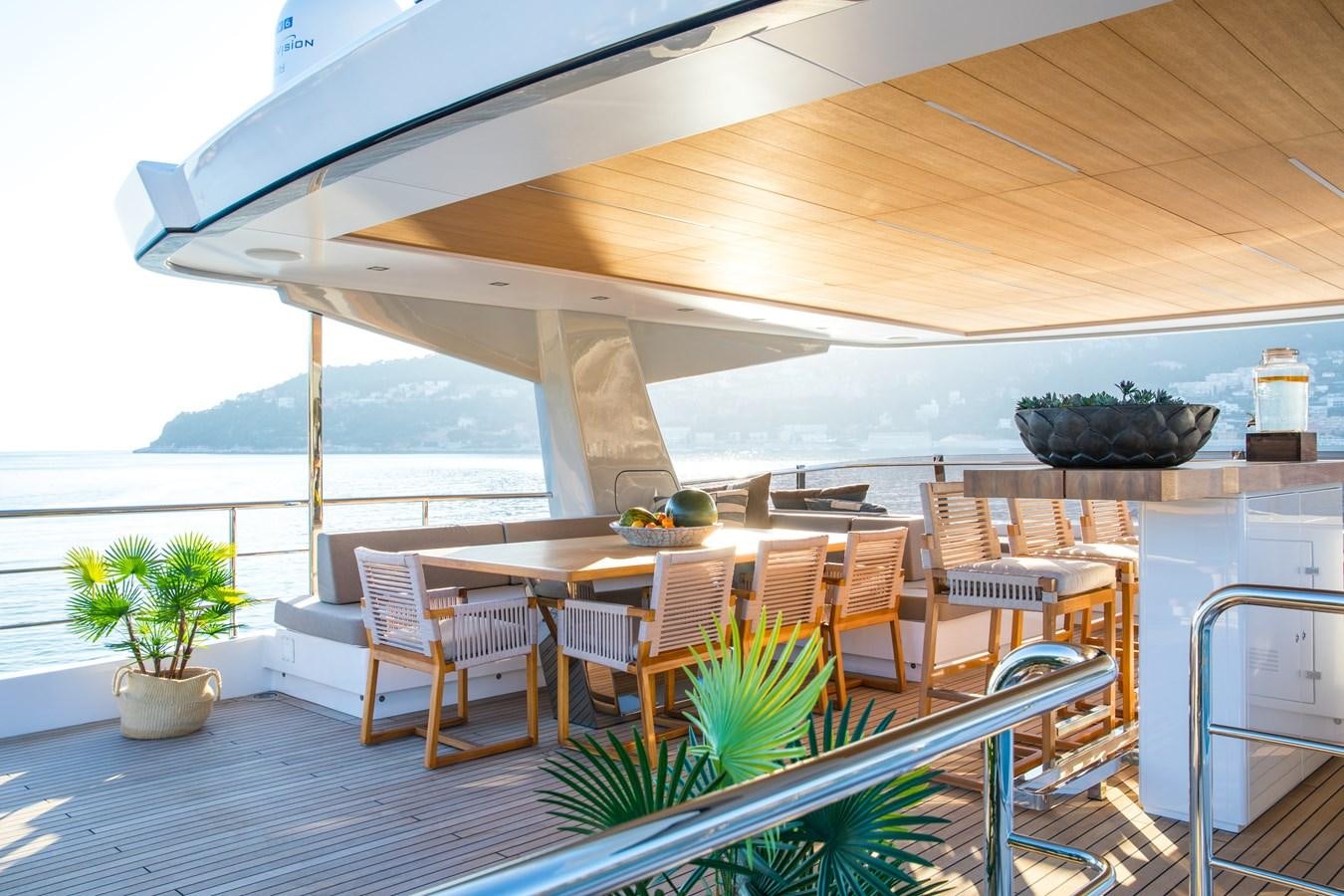 a patio with a table and chairs aboard SABAI Yacht for Sale