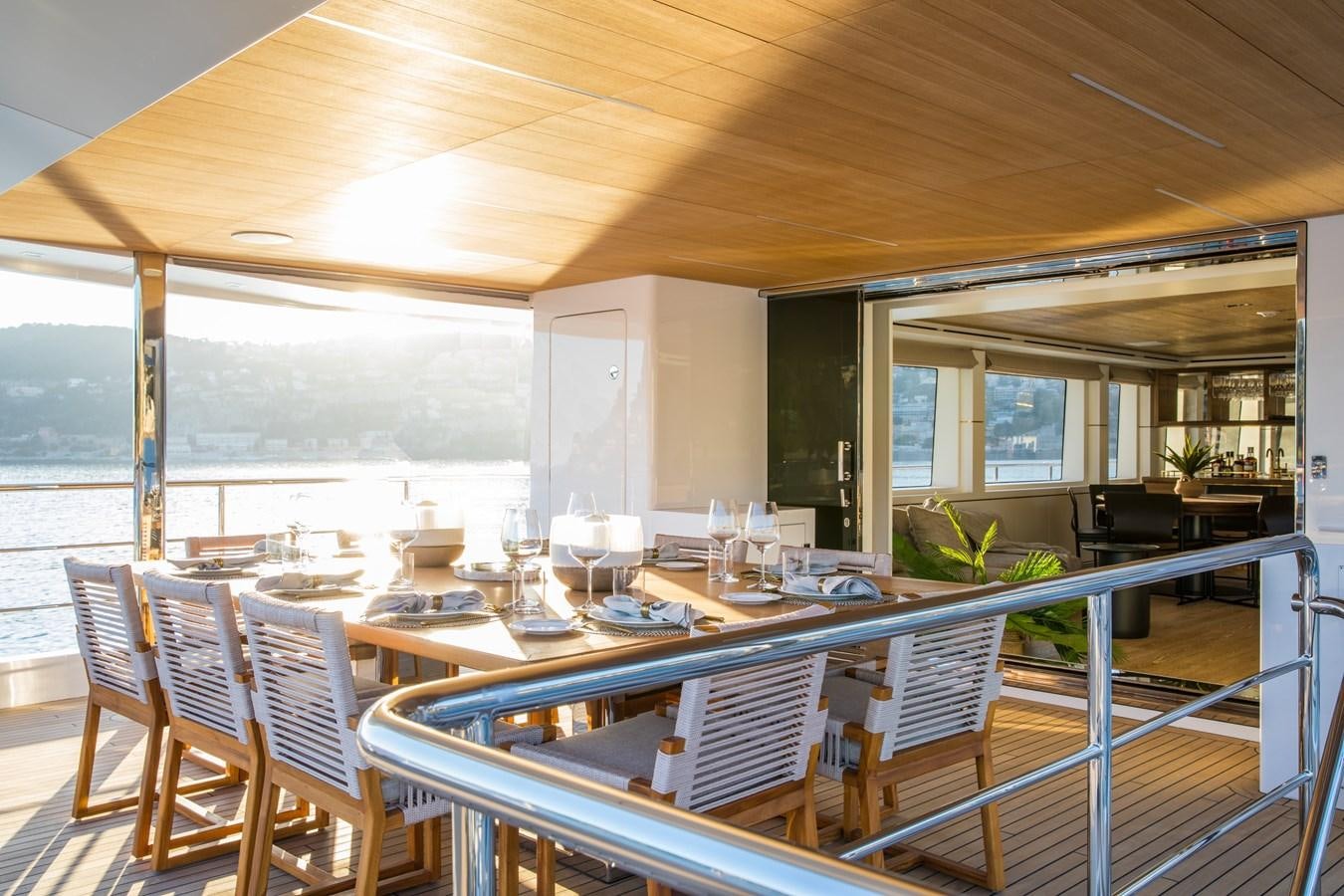 a large room with tables and chairs aboard SABAI Yacht for Sale