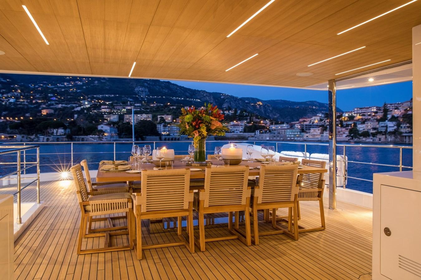 a table with chairs and a plant on it aboard SABAI Yacht for Sale