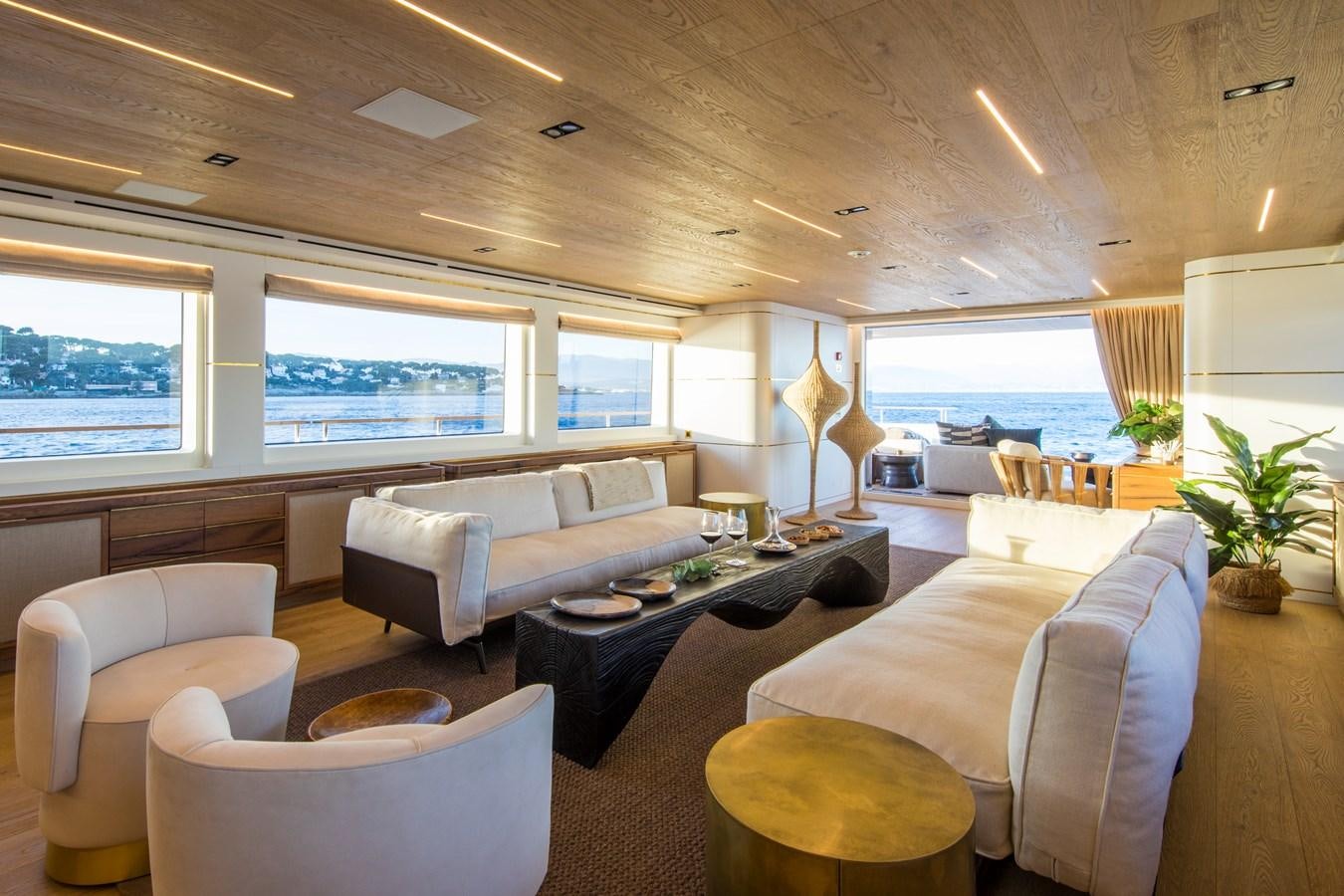 a living room with a large window aboard SABAI Yacht for Sale