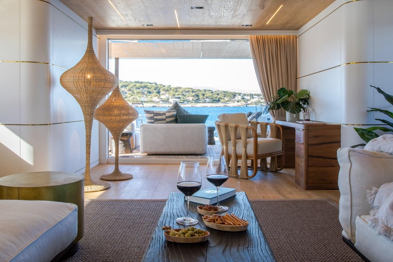 a living room with a fireplace aboard SABAI Yacht for Sale