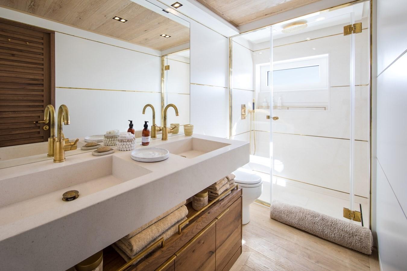 a bathroom with a sink and a toilet aboard SABAI Yacht for Sale