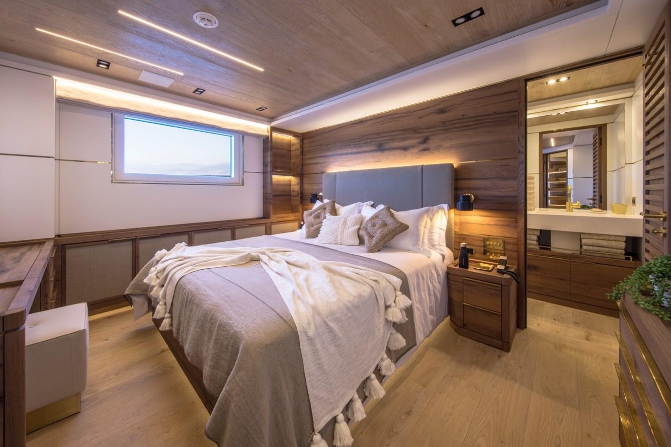 a room with a bed and a window aboard SABAI Yacht for Sale