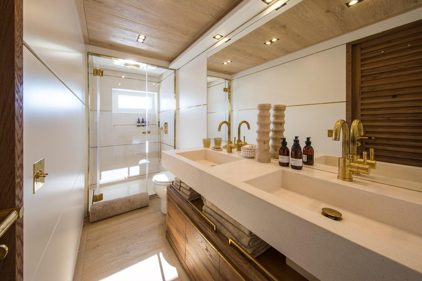 a bathroom with a countertop sink and cabinets aboard SABAI Yacht for Sale