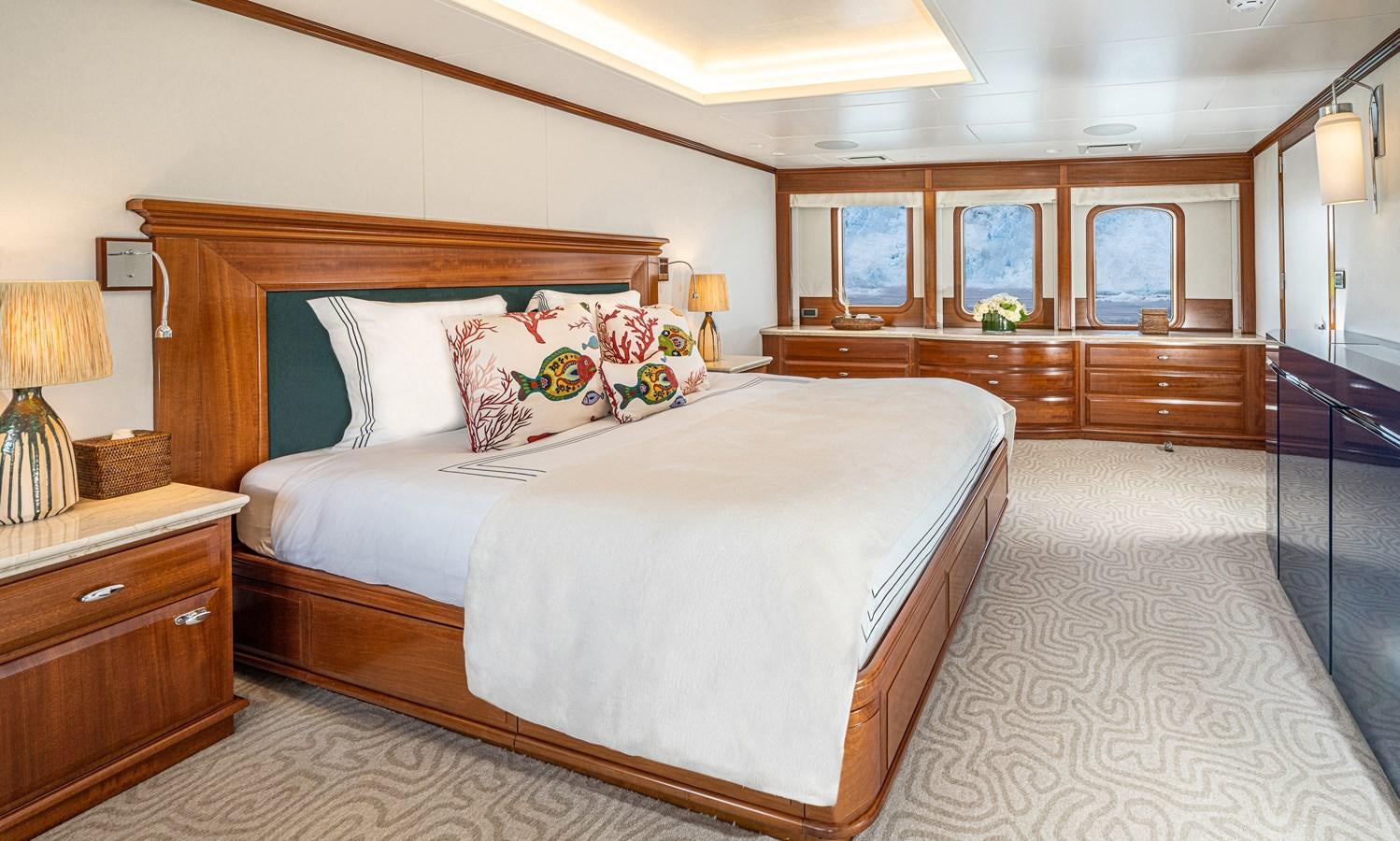 a bedroom with a bed and a desk aboard ASTERIA Yacht for Sale