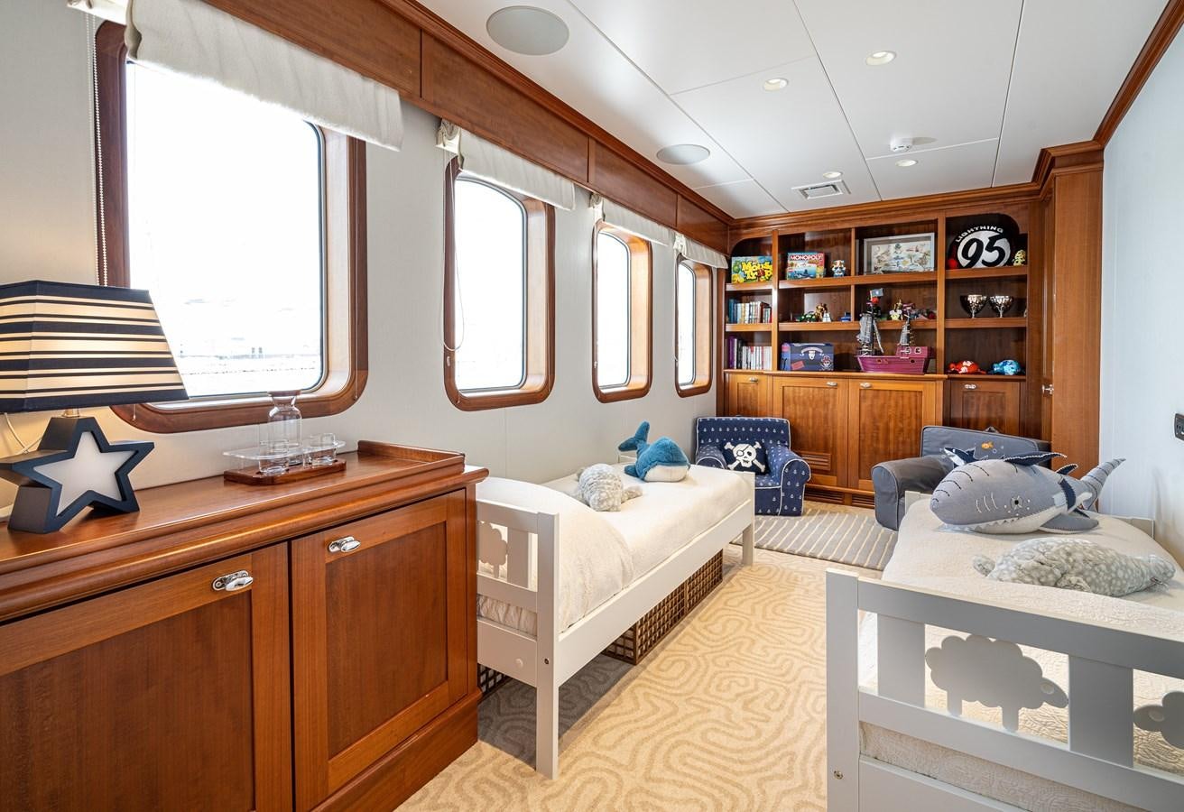 a bedroom with a bed and a desk aboard ASTERIA Yacht for Sale