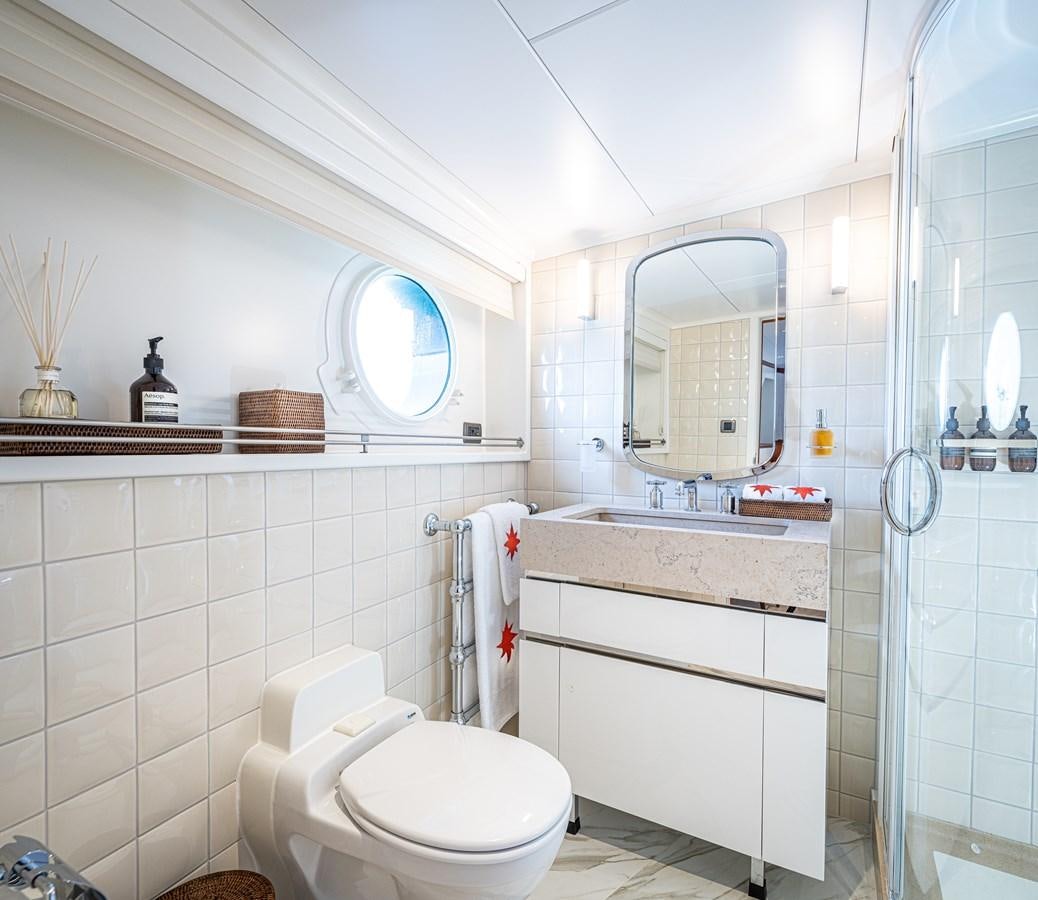 a bathroom with a glass shower aboard ASTERIA Yacht for Sale