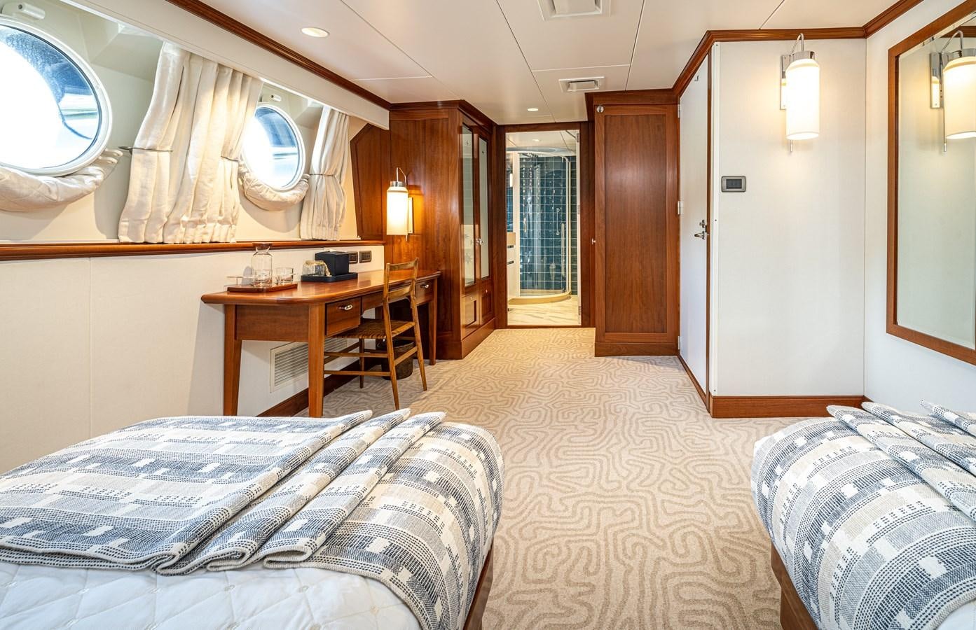 a room with a bed and desk aboard ASTERIA Yacht for Charter