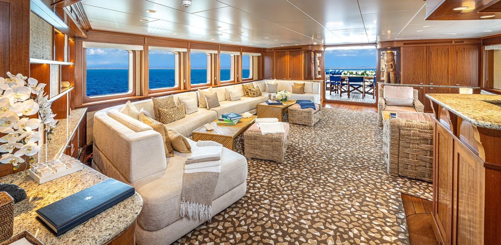 a living room with a couch and a table aboard ASTERIA Yacht for Charter
