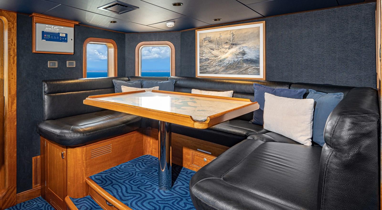 a room with a couch and a table aboard ASTERIA Yacht for Charter