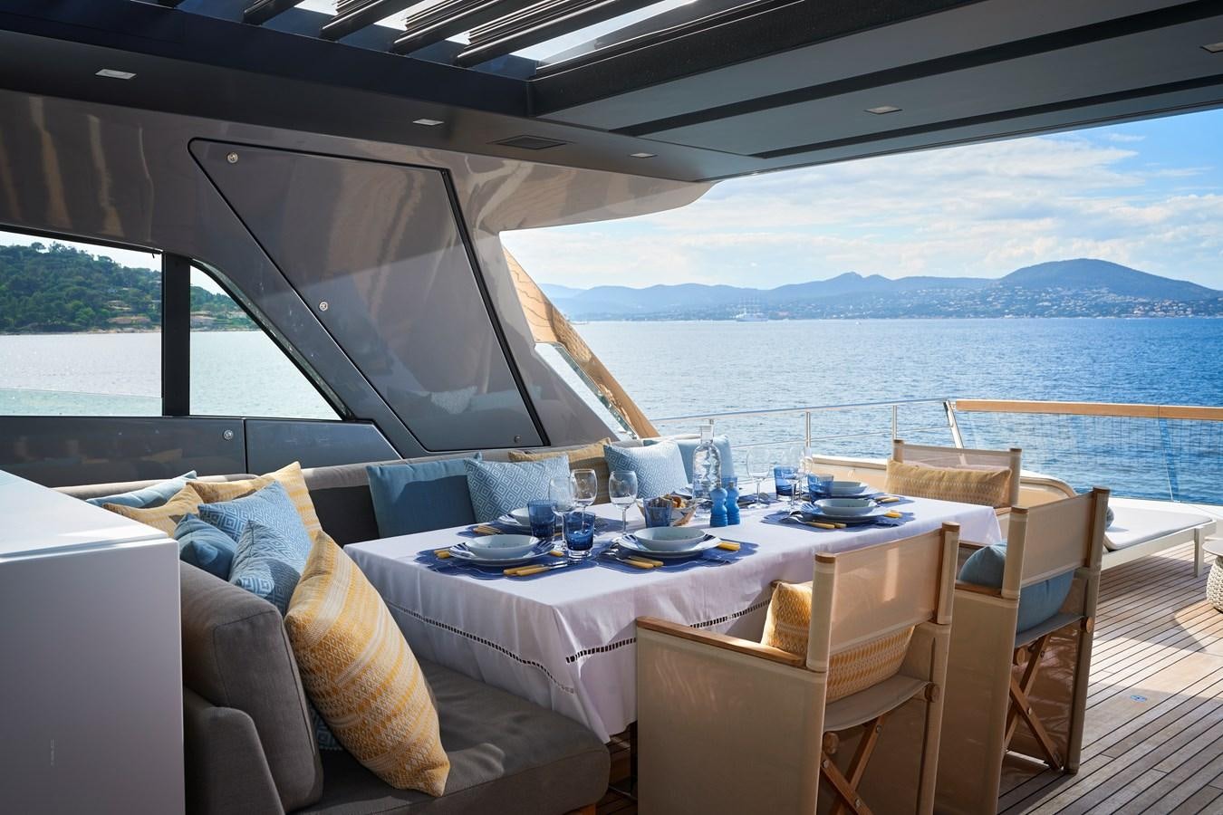 a table set for a meal on a boat aboard OCEAN 6 Yacht for Sale