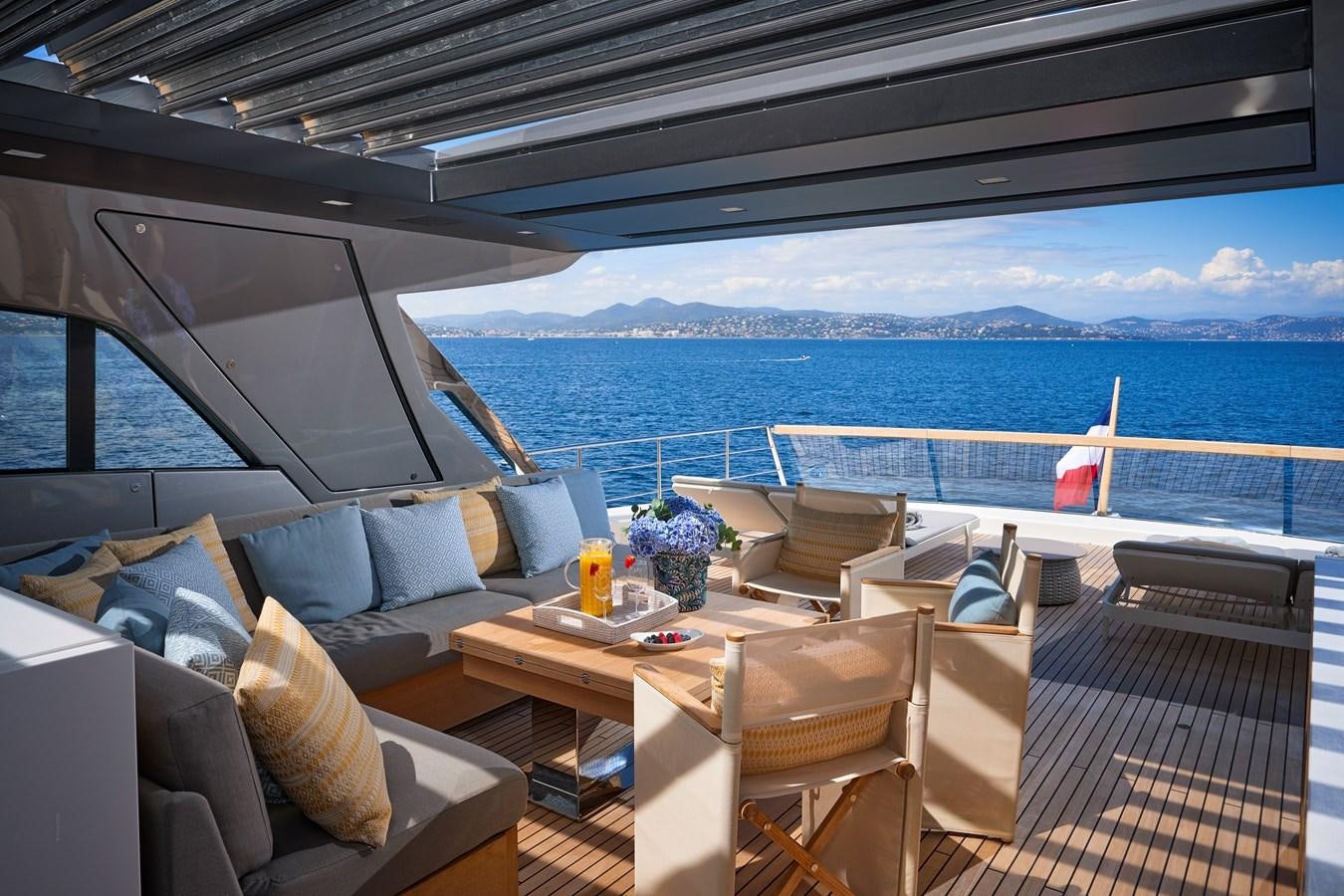 a deck with a view of the ocean and the ocean aboard OCEAN 6 Yacht for Sale