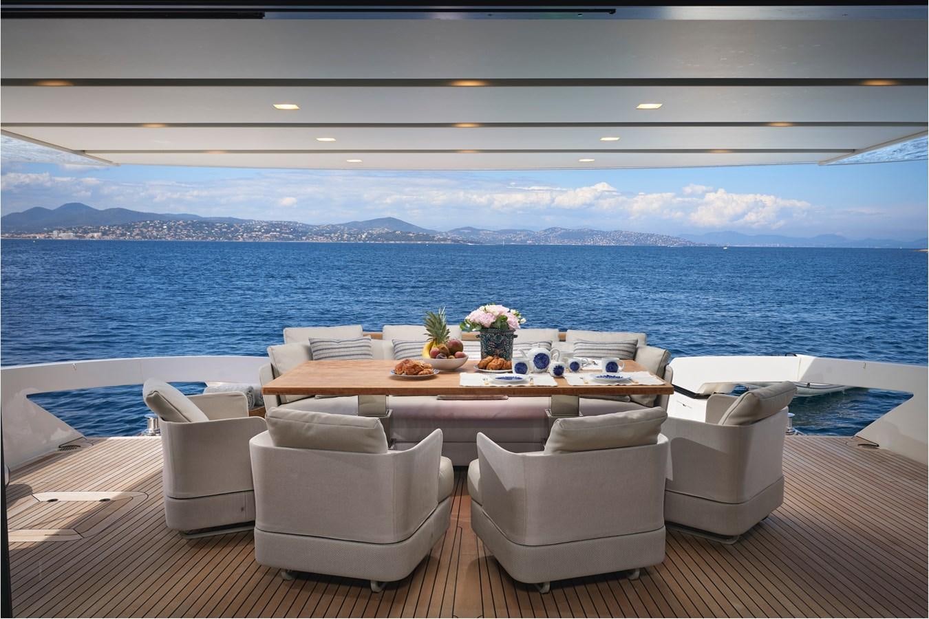a room with a table and chairs aboard OCEAN 6 Yacht for Sale