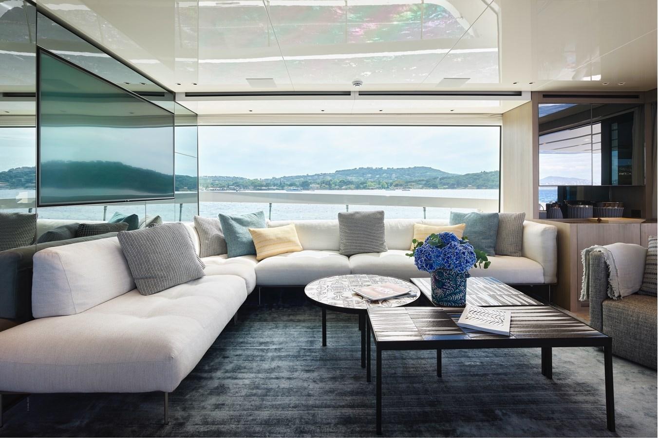 a living room with a large window aboard OCEAN 6 Yacht for Sale