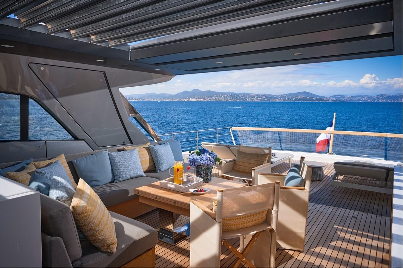 a deck with a view of the ocean and the ocean aboard OCEAN 6 Yacht for Sale