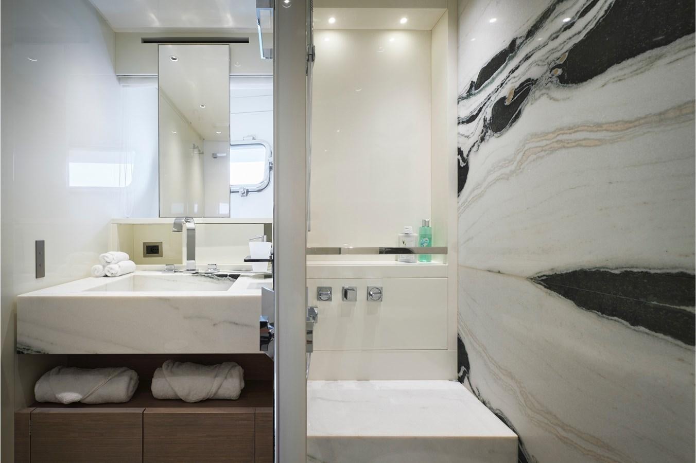 a bathroom with a sink and a bed aboard OCEAN 6 Yacht for Sale