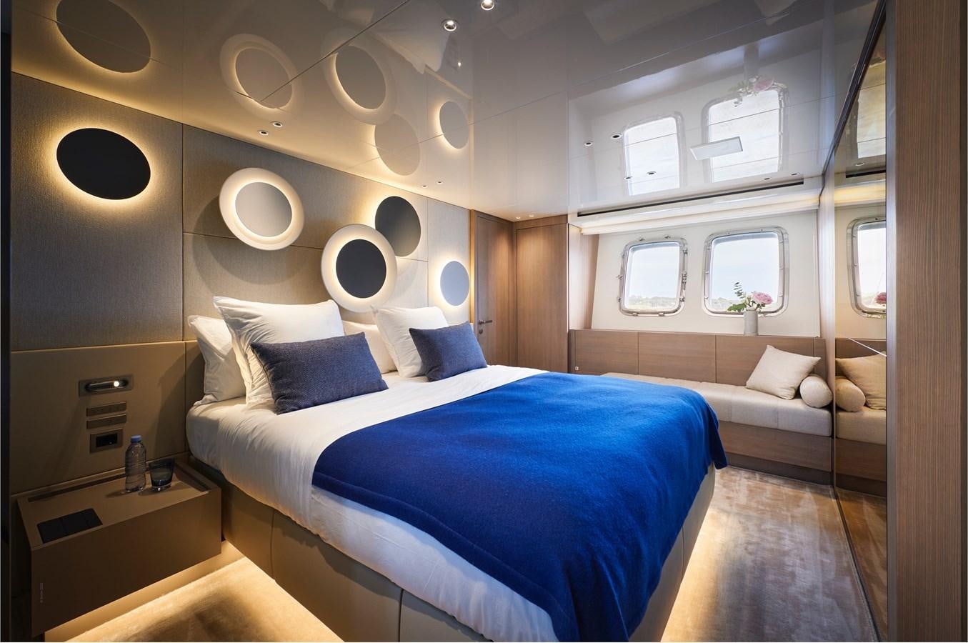 a room with a bed and a mirror aboard OCEAN 6 Yacht for Sale