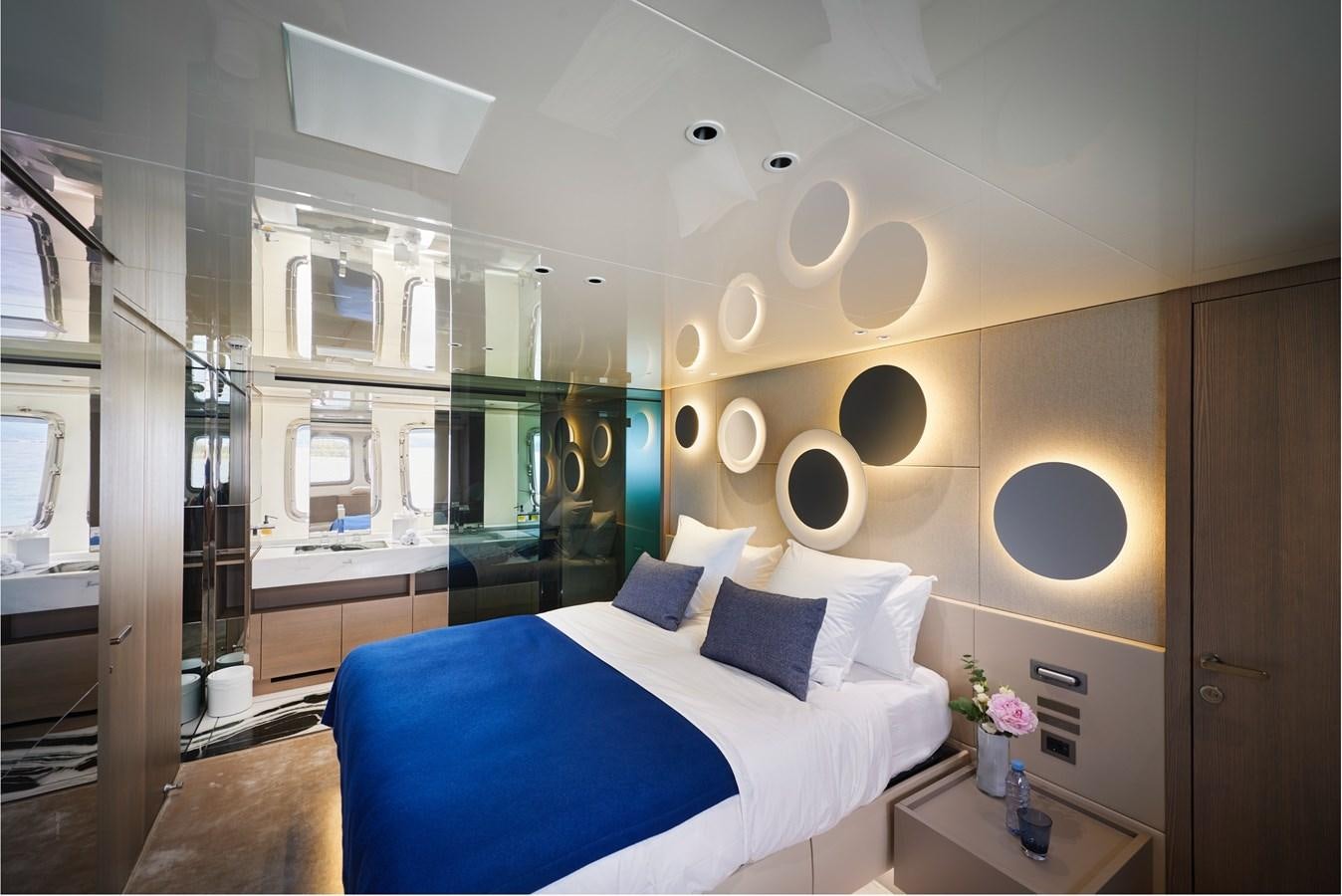 a room with a bed and a mirror aboard OCEAN 6 Yacht for Sale