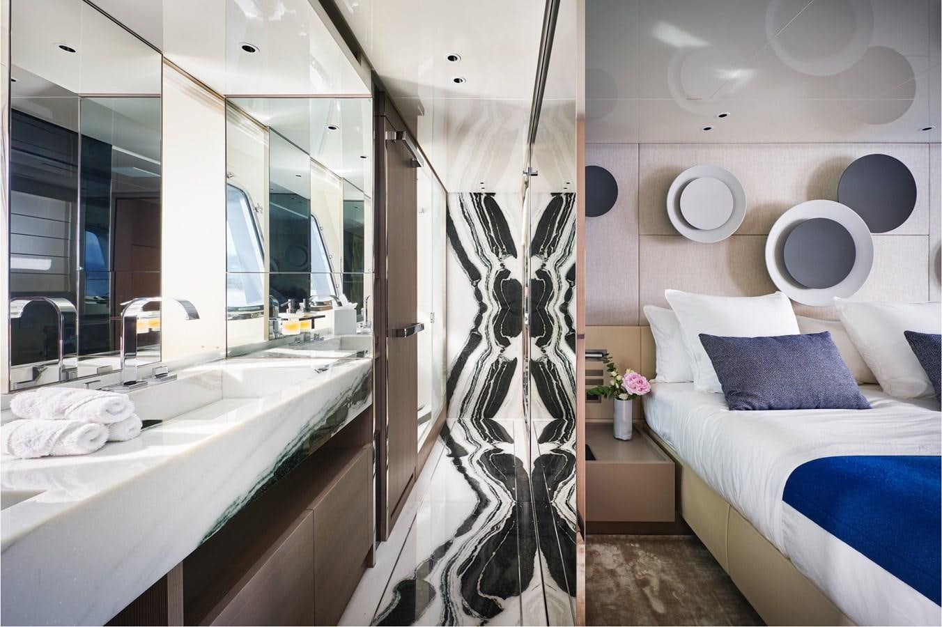 a bathroom with a bathtub and a bed aboard OCEAN 6 Yacht for Sale