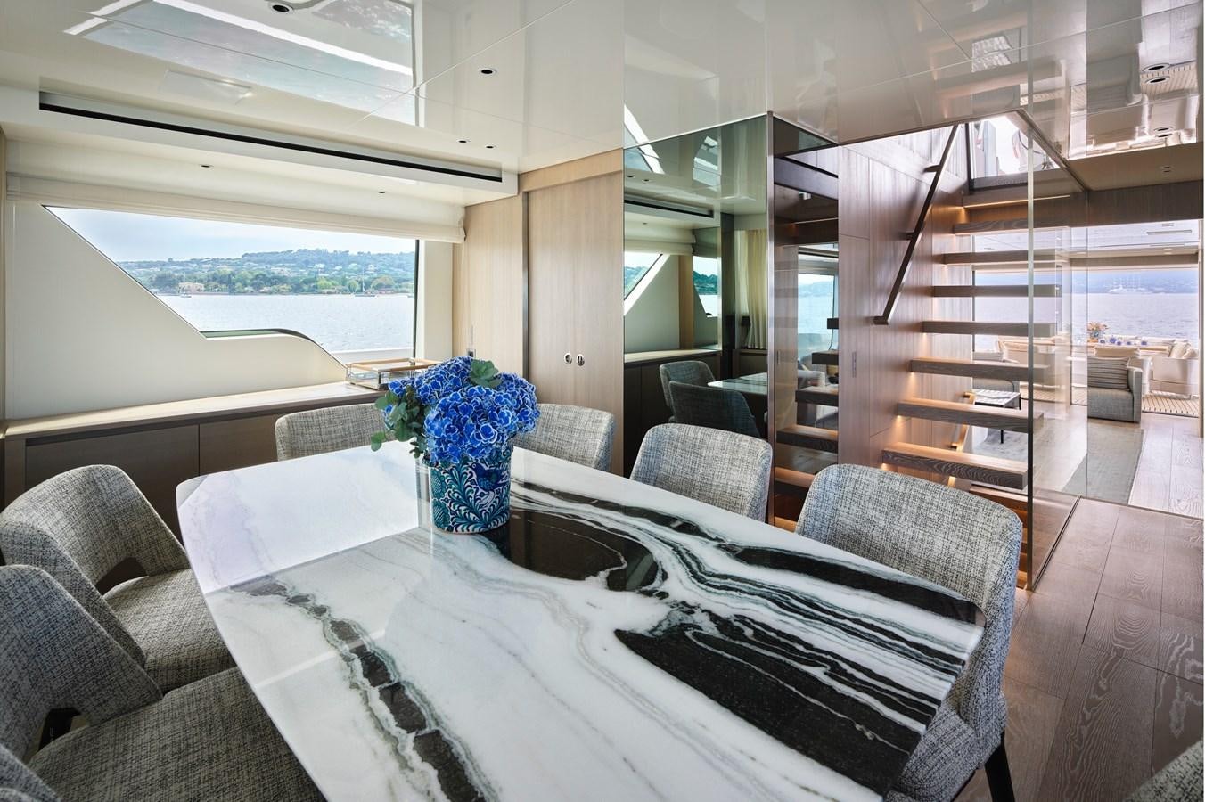 a room with a table and chairs aboard OCEAN 6 Yacht for Sale