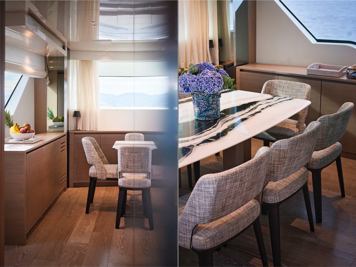 a table with chairs around it aboard OCEAN 6 Yacht for Sale