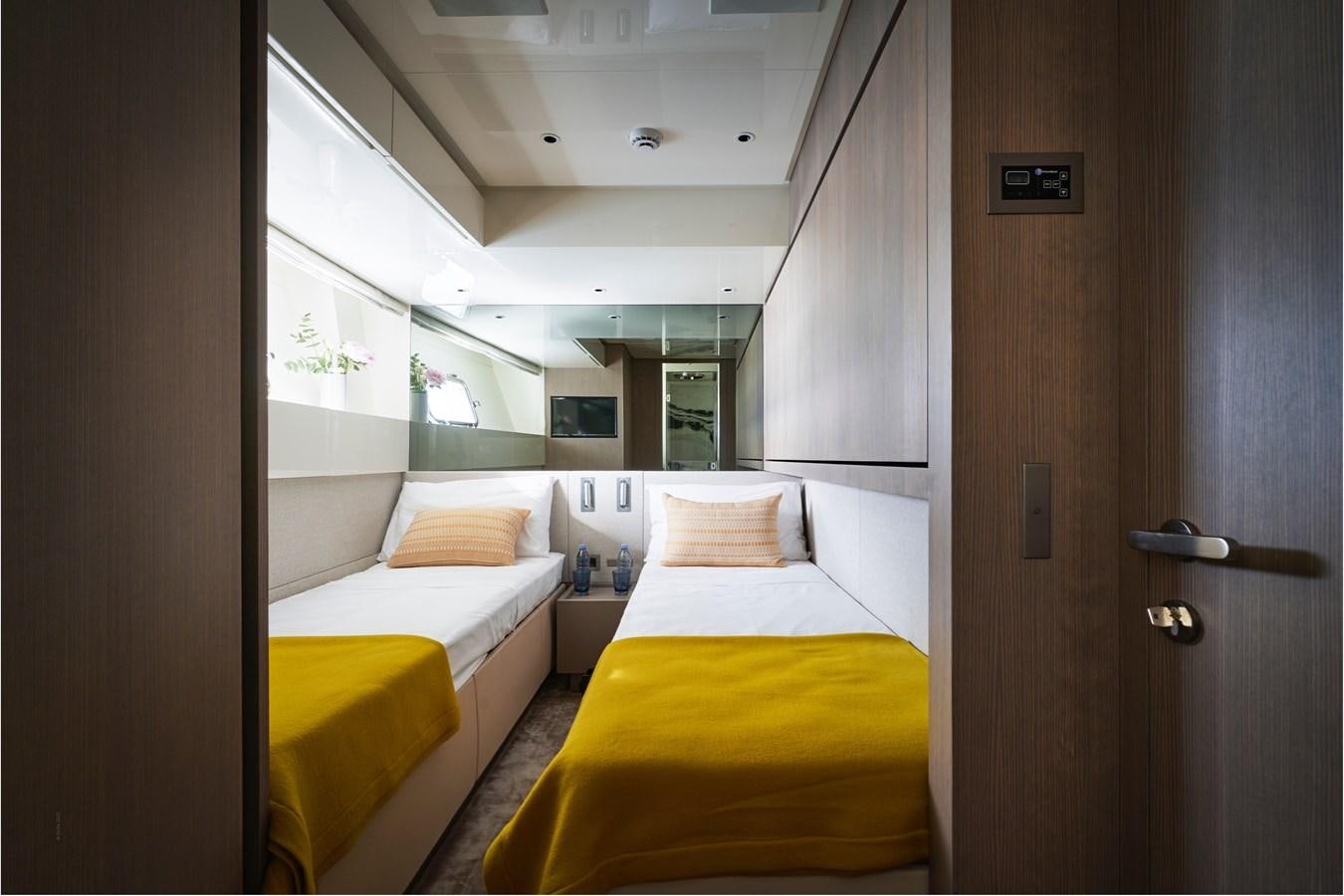 a room with a couple of beds aboard OCEAN 6 Yacht for Sale