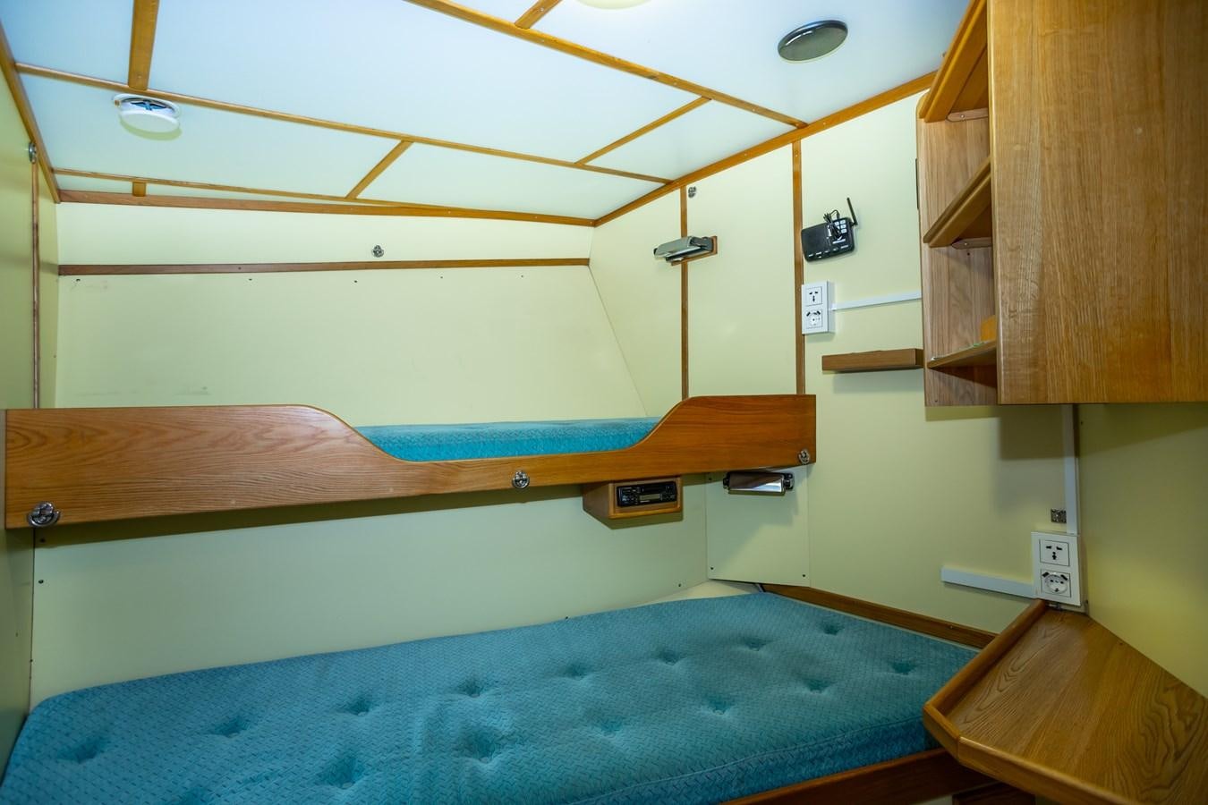 a bunk bed with a blue sheet aboard ASTRA Yacht for Sale
