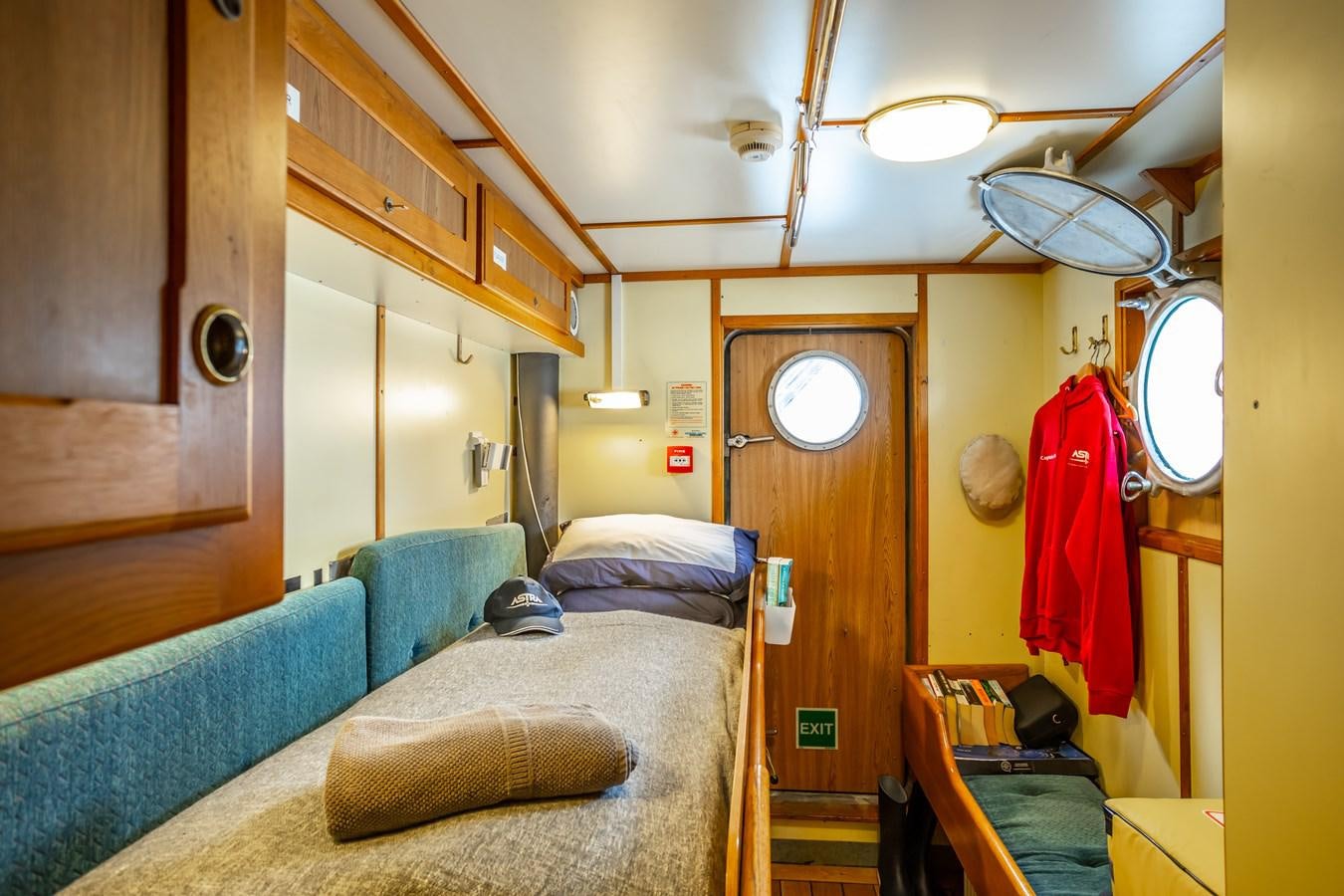 a room with a bed and a mirror aboard ASTRA Yacht for Sale