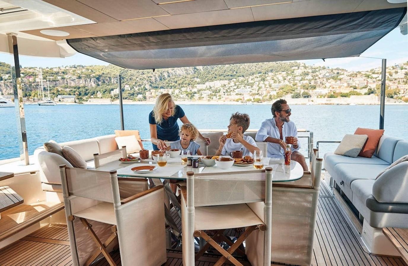 a family sitting at a table aboard ROCKSTAR Yacht for Sale
