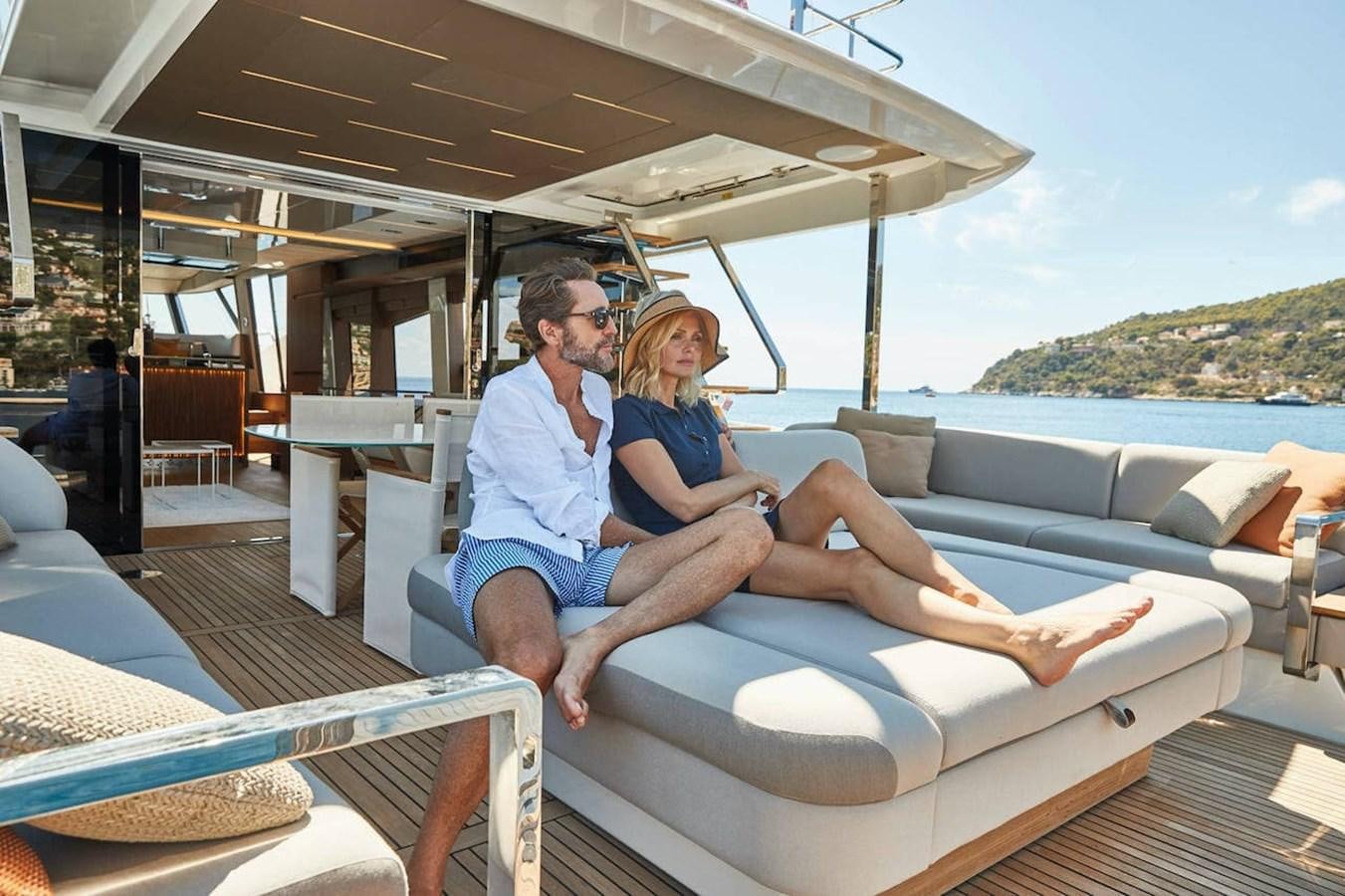 a man and woman sitting on a boat aboard ROCKSTAR Yacht for Sale