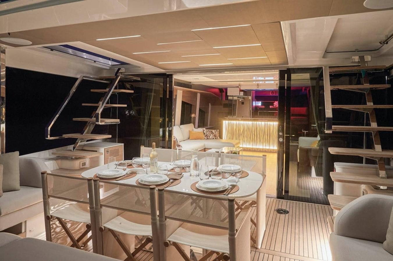 a large room with a table and chairs aboard ROCKSTAR Yacht for Sale