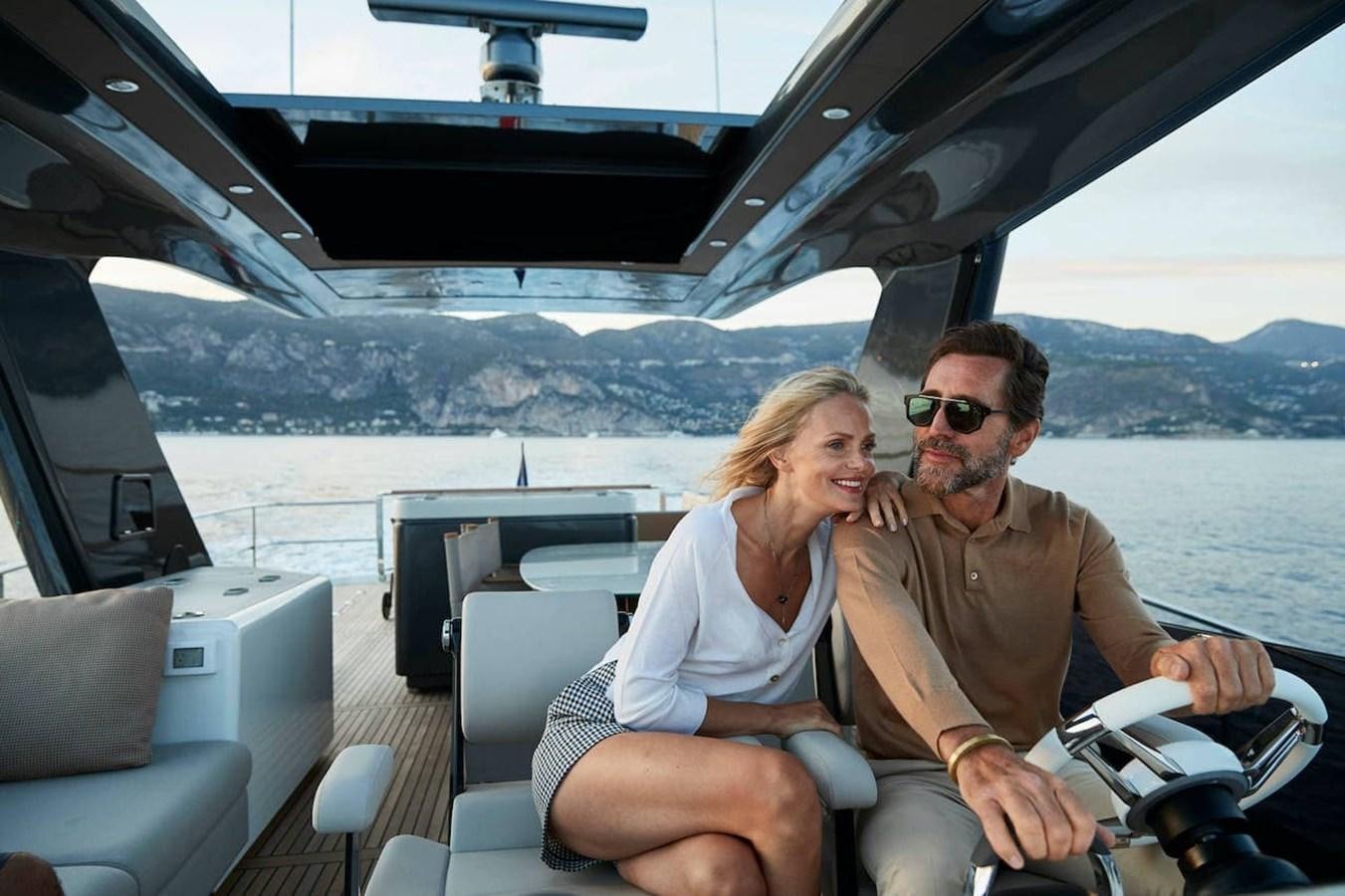 a man and woman sitting in a boat aboard ROCKSTAR Yacht for Sale