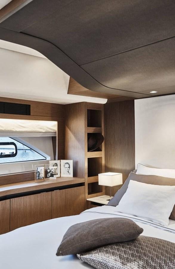 a bedroom with a bed and a television aboard ROCKSTAR Yacht for Sale