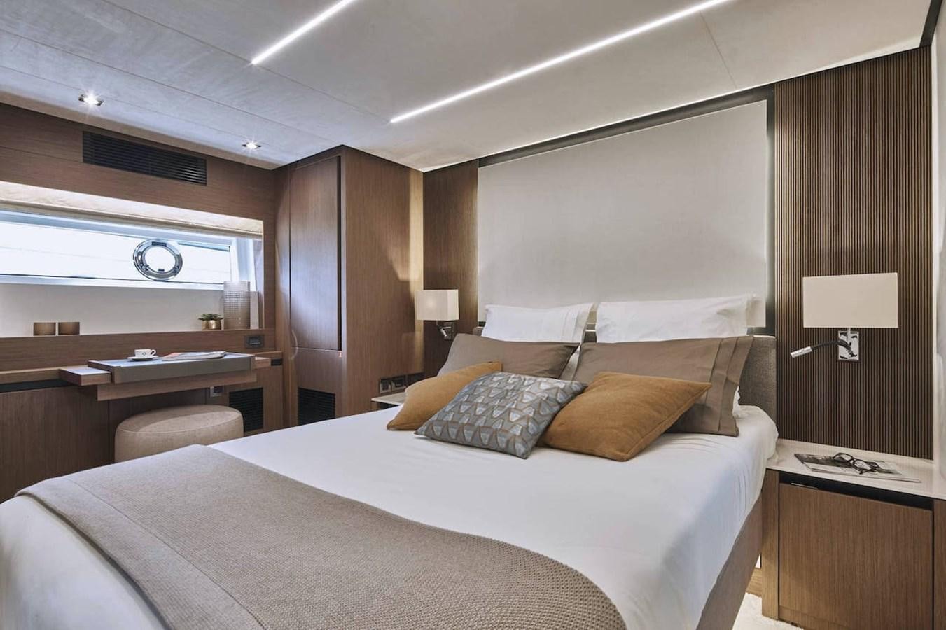 a bed with a white comforter aboard ROCKSTAR Yacht for Sale