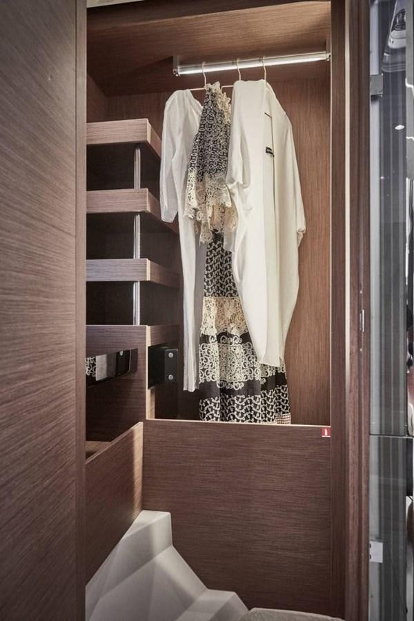 a closet with clothes on the wall aboard ROCKSTAR Yacht for Sale