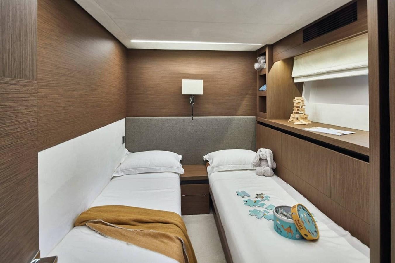a room with a bed and a table aboard ROCKSTAR Yacht for Sale