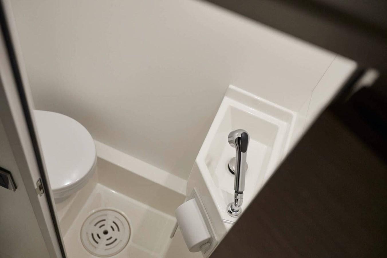 a white toilet with a faucet aboard ROCKSTAR Yacht for Sale
