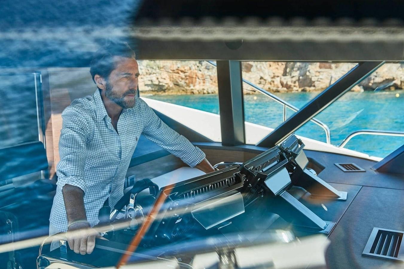 a man sitting in a car aboard ROCKSTAR Yacht for Sale