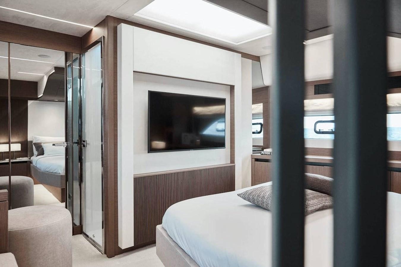 a room with a bed and a television aboard ROCKSTAR Yacht for Sale