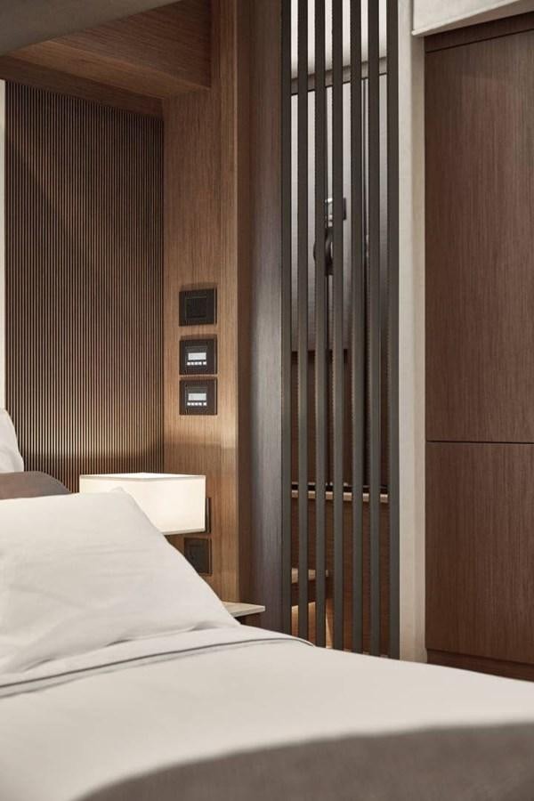 a bed next to a door aboard ROCKSTAR Yacht for Sale