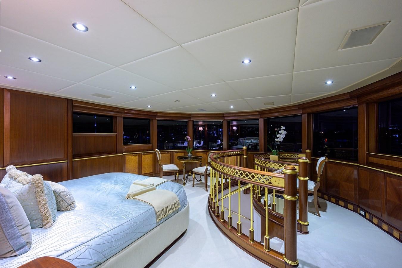 a room with a bed and a table aboard STARSHIP Yacht for Charter