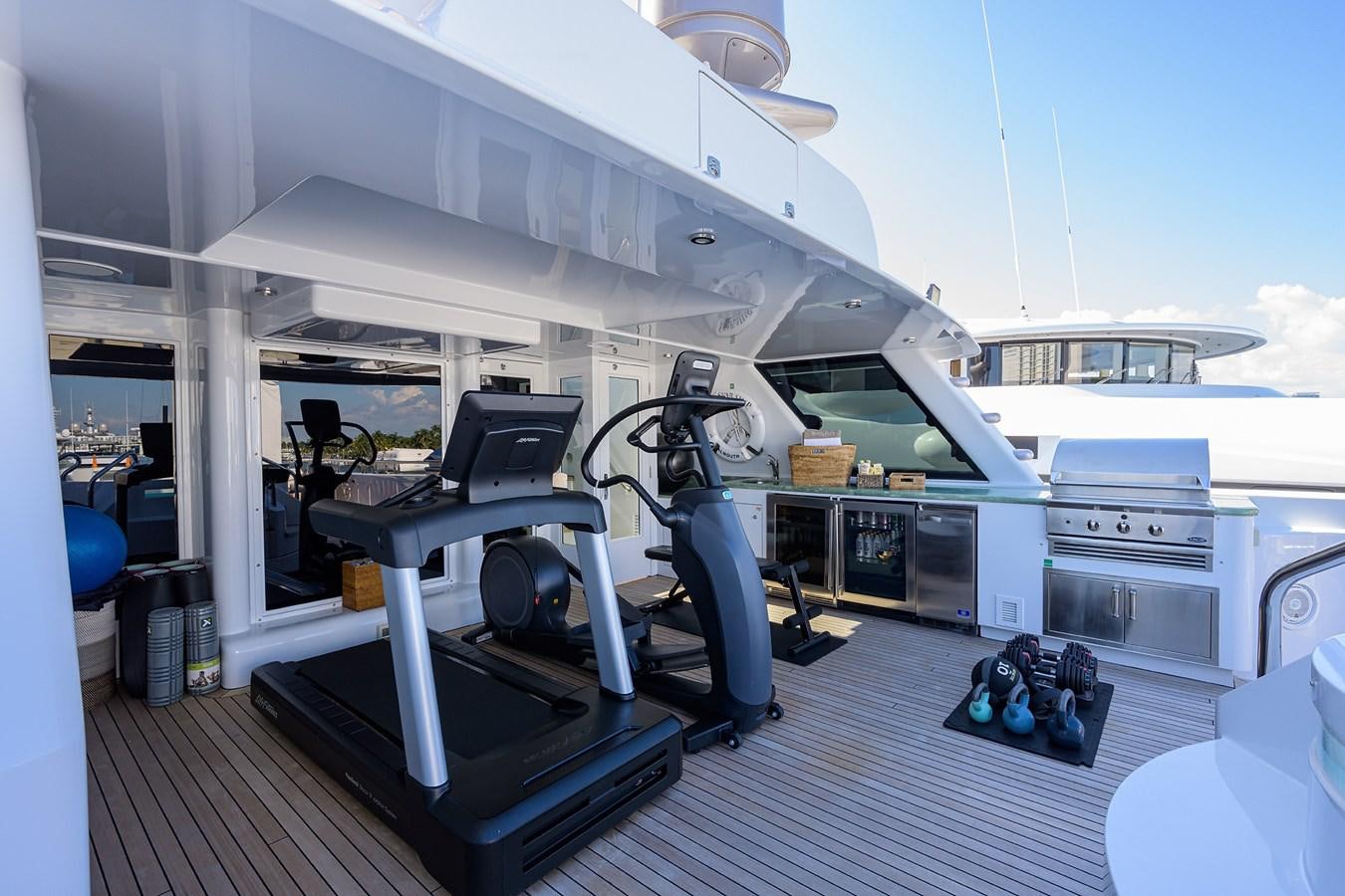 a large gym with equipment aboard STARSHIP Yacht for Charter