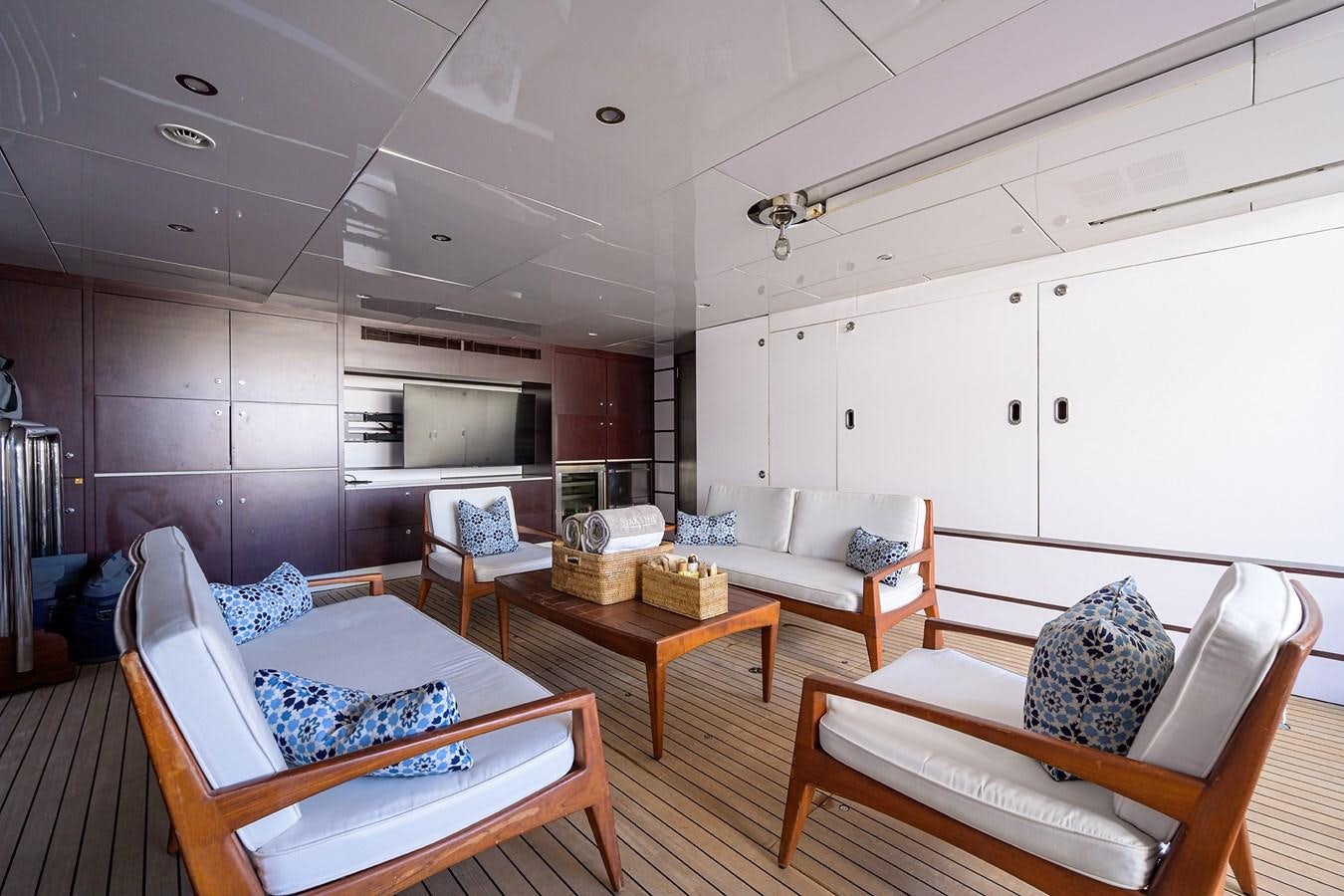 a room with a table chairs and a couch aboard STARSHIP Yacht for Charter