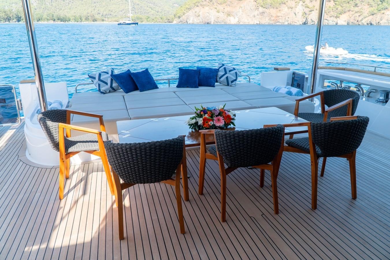 a table and chairs on a deck aboard ARES Yacht for Sale