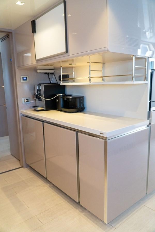 a kitchen with white cabinets aboard ARES Yacht for Sale