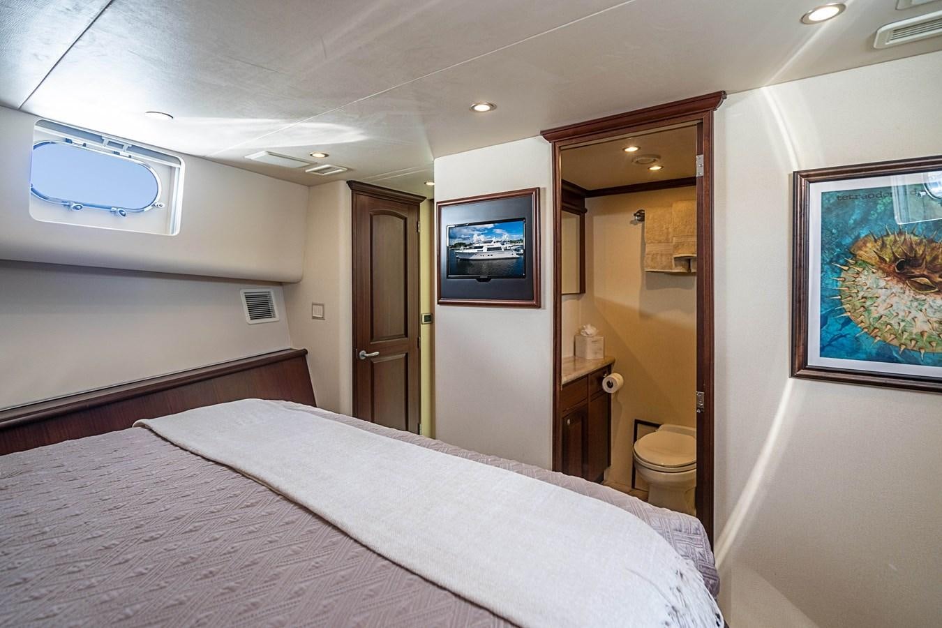 a hotel room with a bed and tv aboard TRUE NORTH Yacht for Sale