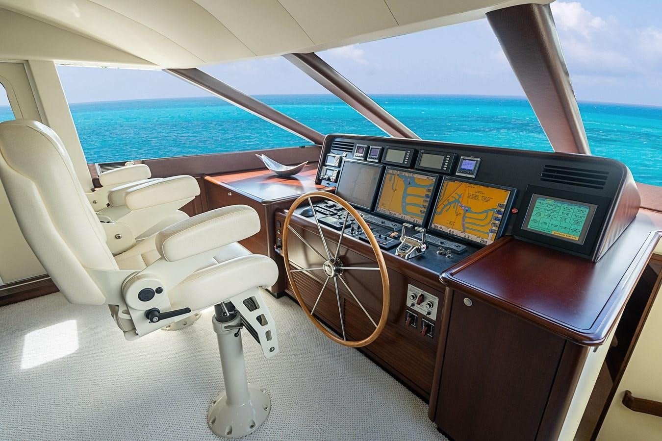 a boat with a seat and steering wheel aboard TRUE NORTH Yacht for Sale