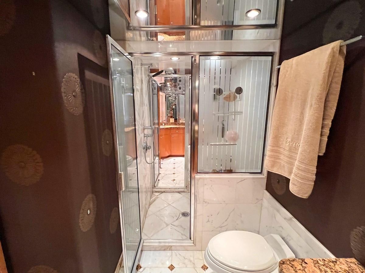 a bathroom with a glass shower aboard DESTINI IV Yacht for Sale