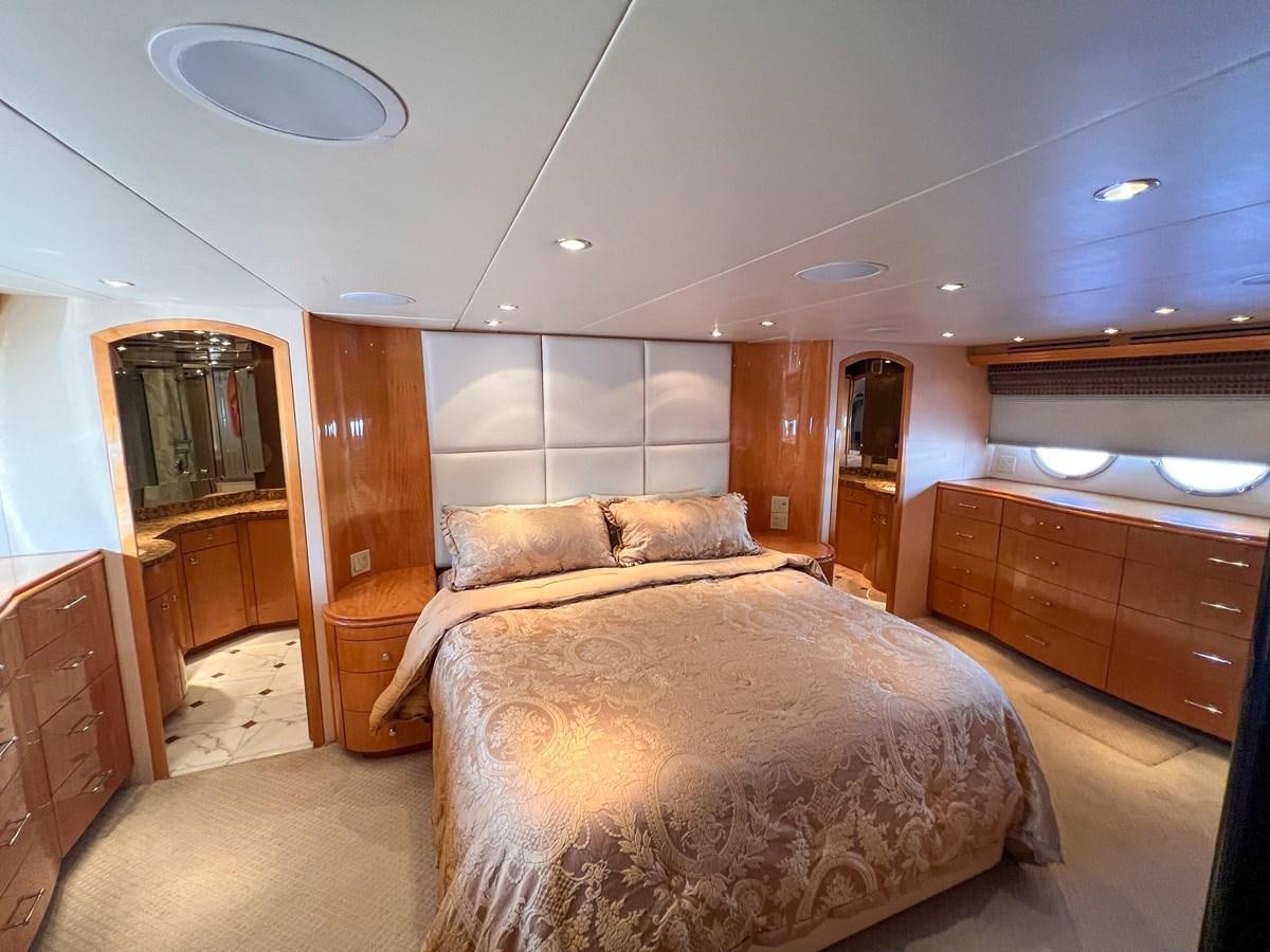a bedroom with a bed and a mirror aboard DESTINI IV Yacht for Sale